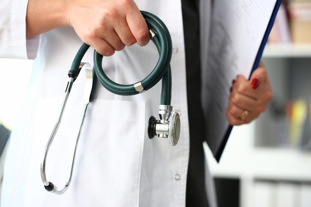What does the doctor see under the microscope when examining a biopsy and what are the possible diagnoses?