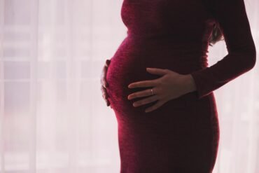 What happens if a woman becomes pregnant before completing the three doses?